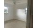 Bedroom featuring tile floors, a ceiling fan, and natural light from dual windows at 736 Nw 31St Ct, Winter Haven, FL 33881