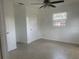 Comfortable bedroom featuring durable tile flooring, a ceiling fan, and a storage closet at 736 Nw 31St Ct, Winter Haven, FL 33881