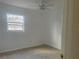 Bedroom featuring tile floors, a ceiling fan, and natural light from the window at 736 Nw 31St Ct, Winter Haven, FL 33881