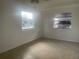 Bright, freshly painted room features tile flooring and natural light through two large windows at 736 Nw 31St Ct, Winter Haven, FL 33881