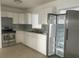 Modern kitchen equipped with stainless steel appliances, white cabinets, and sleek countertops at 736 Nw 31St Ct, Winter Haven, FL 33881
