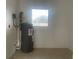 Practical utility area showcasing a modern water heater and durable tiled floor at 736 Nw 31St Ct, Winter Haven, FL 33881