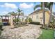 Lush backyard with an outdoor dining area and tropical landscaping at 7623 Excitement Dr, Reunion, FL 34747