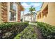 Picturesque backyard view showcasing manicured hedges, lush greenery, and a charming patio with a view of the property at 7623 Excitement Dr, Reunion, FL 34747