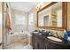 Bathroom with a double sink vanity, a soaking tub, tile flooring, and a shower at 7623 Excitement Dr, Reunion, FL 34747