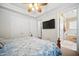 Bedroom with a large bed, a mounted television and view of the Primary bath at 7623 Excitement Dr, Reunion, FL 34747