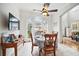 Dining area with arched windows, tile floors, and a television on the wall at 7623 Excitement Dr, Reunion, FL 34747
