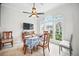 Bright dining area featuring large arched windows, ceiling fan, and a view to the exterior at 7623 Excitement Dr, Reunion, FL 34747