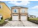Charming two-story home featuring a stone facade and two-car garage and well manicured yard at 7623 Excitement Dr, Reunion, FL 34747