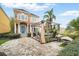 Beautiful home with a brick driveway and outdoor seating area with pergola at 7623 Excitement Dr, Reunion, FL 34747