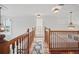 Upstairs hallway with wood floors and natural light at 7623 Excitement Dr, Reunion, FL 34747