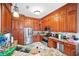 Spacious kitchen featuring stainless steel appliances, granite counters, and wooden cabinets at 7623 Excitement Dr, Reunion, FL 34747