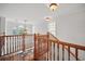 Upstairs landing with wood floors, natural light, and wood banister at 7623 Excitement Dr, Reunion, FL 34747