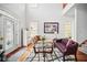 Bright living room featuring hardwood floors and a cozy seating arrangement at 7623 Excitement Dr, Reunion, FL 34747