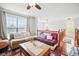Living room with ceiling fan, hardwood flooring, and lots of natural light at 7623 Excitement Dr, Reunion, FL 34747