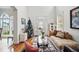 Bright, open living room featuring large windows and gleaming hardwood floors at 7623 Excitement Dr, Reunion, FL 34747