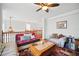 Upstairs living room with hardwood floors, ceiling fan, and comfortable seating at 7623 Excitement Dr, Reunion, FL 34747
