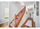 View of carpeted staircase with wood handrail and festive holiday decorations at 7623 Excitement Dr, Reunion, FL 34747