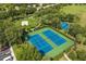 Aerial view highlighting tennis courts, basketball court, and sand volleyball court at 7660 Otterspool St, Kissimmee, FL 34747