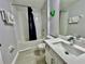 Bathroom featuring a tub, sink, toilet, and a custom Hulk Fist wall decoration at 7660 Otterspool St, Kissimmee, FL 34747