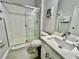 Clean bathroom featuring a glass-enclosed shower and modern vanity at 7660 Otterspool St, Kissimmee, FL 34747