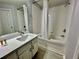 Bright bathroom featuring a vanity with white cabinets and a combined shower and bathtub at 7660 Otterspool St, Kissimmee, FL 34747