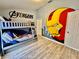 Avengers themed bedroom with hardwood floors, gray bunk beds and a custom Iron Personal wall mural at 7660 Otterspool St, Kissimmee, FL 34747
