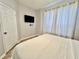 Comfortable bedroom with a queen bed, neutral decor, and ample natural light at 7660 Otterspool St, Kissimmee, FL 34747