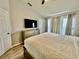 Spacious bedroom with a queen bed, vaulted ceilings, and ample natural light at 7660 Otterspool St, Kissimmee, FL 34747