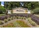 Windsor Hills community sign surrounded by manicured landscaping and lush trees, creating a welcoming entrance at 7660 Otterspool St, Kissimmee, FL 34747