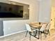 Dining room with modern wood table, chairs, and a wall-mounted television at 7660 Otterspool St, Kissimmee, FL 34747