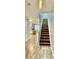 Inviting entryway with stairs, wood floors, and open views to the living area at 7660 Otterspool St, Kissimmee, FL 34747