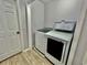 Laundry room featuring a white washer and dryer with a laundry basket on top at 7660 Otterspool St, Kissimmee, FL 34747