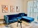 Modern living room featuring a stylish blue velvet sectional sofa at 7660 Otterspool St, Kissimmee, FL 34747