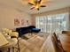 Spacious living room with a modern blue velvet sofa and bright, natural light at 7660 Otterspool St, Kissimmee, FL 34747