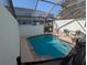 Relaxing screened-in pool area with an in-ground pool and outdoor seating at 7660 Otterspool St, Kissimmee, FL 34747