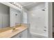 This is a bathroom featuring a bathtub with shower and white vanity at 8122 Yellow Crane Dr, Kissimmee, FL 34747