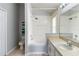 Bright bathroom features a tub with shower, neutral tile floor, vanity with sink, and integrated lighting at 8122 Yellow Crane Dr, Kissimmee, FL 34747