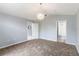 This is a carpeted bedroom that is connected to a bathroom at 8122 Yellow Crane Dr, Kissimmee, FL 34747
