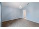 Cozy bedroom with blue walls, carpet, and ensuite bathroom access at 8122 Yellow Crane Dr, Kissimmee, FL 34747