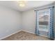This is a carpeted bedroom with blue curtains and a window at 8122 Yellow Crane Dr, Kissimmee, FL 34747