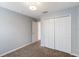 Bedroom featuring neutral walls and carpet, a modern light fixture, and a double door closet at 8122 Yellow Crane Dr, Kissimmee, FL 34747