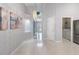 Bright foyer leading to laundry area with stainless steel appliances and tile flooring at 8122 Yellow Crane Dr, Kissimmee, FL 34747
