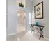 Inviting foyer with tile floors, neutral walls, arched entryway, and decorative lighting at 8122 Yellow Crane Dr, Kissimmee, FL 34747