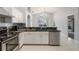 Modern kitchen featuring black granite countertops, stainless steel appliances, and tile floors at 8122 Yellow Crane Dr, Kissimmee, FL 34747