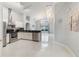 Modern kitchen with stainless steel appliances, white cabinets, and black countertops at 8122 Yellow Crane Dr, Kissimmee, FL 34747