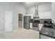 Modern kitchen with stainless steel appliances, granite countertops, and white cabinetry at 8122 Yellow Crane Dr, Kissimmee, FL 34747