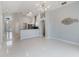 Open living room featuring tile floors, high ceilings, kitchen access and modern lighting at 8122 Yellow Crane Dr, Kissimmee, FL 34747
