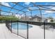 The screened pool area features a fenced pool and a lounge chair on the patio at 8122 Yellow Crane Dr, Kissimmee, FL 34747