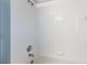 Clean shower with a showerhead, faucet, and white tiled walls for a serene bathing experience at 8122 Yellow Crane Dr, Kissimmee, FL 34747